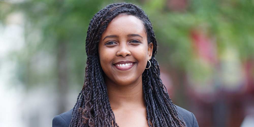 Portrait of a woman smiling in a business suit.