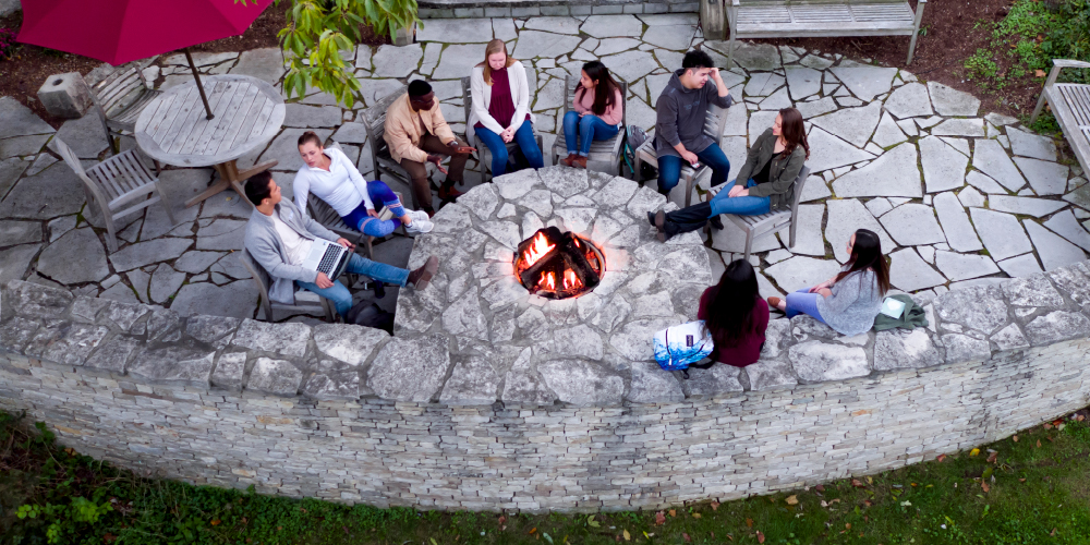 Drone image of students around firepit