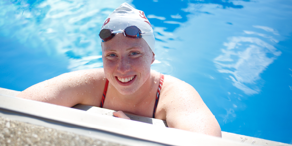 Swimmer with arms on edge of pool