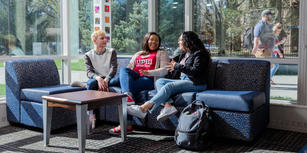 Three students in residence hall lounge